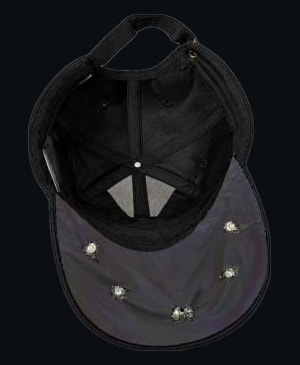The underside of a black cap brim with about six small LEDs set into a reflective lining